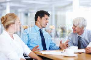 Business men discussing with female executive. Portrait of business men discussing with female executive at meeting.