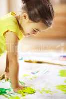You got to make a mess to make a masterpiece. shot of a mischievous child making a mess while painting.