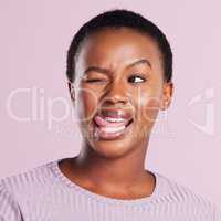 Lifes too short to not be weird. Studio shot of a young woman making a silly face against a pink background.