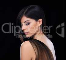 Hair and beauty unmatched. Studio shot of a stunning female with her long hair thrown over her shoulder.