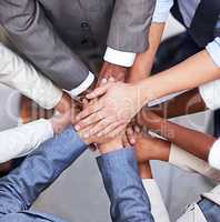 Go, go power business. Cropped shot of a group of businesspeople standing in a huddle with their hands piled up.