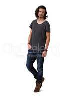 He has a devil-may-care attitude. Handsome young casual man standing against a white background - full length.