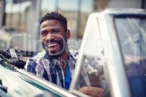 Nothing beats a really good drive. A handsome young man driving in his convertible.