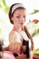 Working for the body I want. Shot of an attractive young woman working out with dumbells.