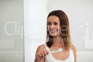 Make tooth decay a problem of the past. Shot of a woman brushing her teeth in the bathroom.