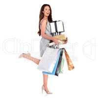 Clothes, shoes, accessories... I bought them all. Portrait of a young woman carrying shopping bags and boxes isolated on white.