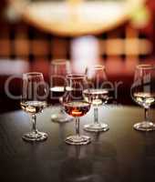 The many varieties of wine. Shot of wine glasses laid out for tasting at a wine cellar.