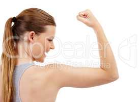 My bicep muscles are getting stronger. A teenage girl checking out her bicep muscles after a workout.