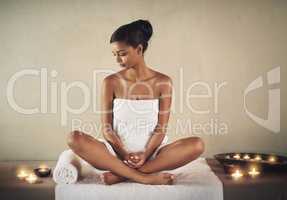 Spa indulgence. Full length shot of a young woman sitting on a massage table at the spa.
