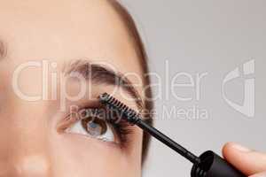 Easy steps to perfect beauty. Closeup shot of a young woman applying mascara in studio.
