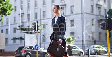Off to her next meeting. A young businesswoman walking in the city on her way to work.