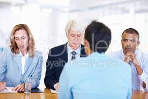 The interview. Portrait of business panel interviewing an applicant for job.