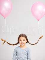 Do you like my hairstyle. Studio portrait of a cute little girl with balloons tied to her pigtails.