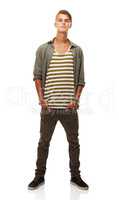 No trend or style escapes his eye. A full length studio shot of a stylishly dressed young man.