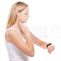 Monitoring her pulse rate carefully. Young woman taking her pulse rate against a white background.