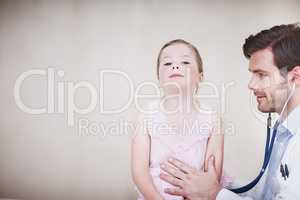 Breathe in deeply.... A young male doctor performing a medical examination on a little girl.