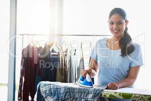 The last step in having clean clothes. Shot of a woman doing her daily chores at home.