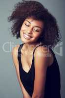 Her personality shines through. A smiling young woman with an afro.