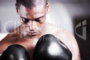 Visualizing success. A young boxer taking some time to visualize before a fight.