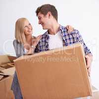 So glad we finally moved into our new home. Shot of a happy young couple on their moving in day.