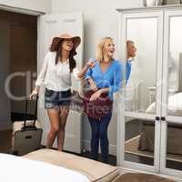 Theyre impressed with their room. Shot of two young women arriving at their holiday accommodation.