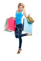 In my defence, I was left unsupervised. Studio shot of an attractive young woman holding shopping bags.