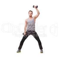 Toning his arms. A fit young man working out with dumbbells while isolated on a white background.