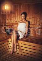 Luxuriating in the steam. Full length portrait of a young woman relaxing in the sauna at a spa.