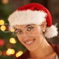 The spirit of Christmas. Portrait of an attractive young woman in front of a Christmas tree.