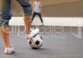 Ready to score. Cropped image of a mans foot on a soccer ball in the street.