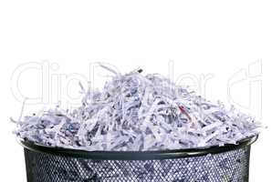 Leaving no shred of evidence. Studio shot of shredded paper in a dustbin against a white background.