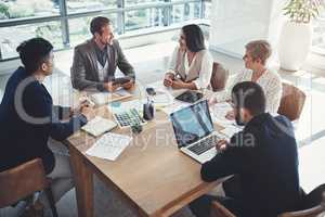 Planning ways to get success within their grasp. Shot of a diverse group of businesspeople having a meeting in an office.