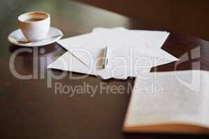 Authors apparatus. Shot of stationery and a cup of coffee on a desk.