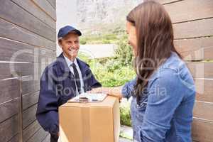 I always use a trustworthy courier. Shot of a friendly delivery man delivering a package to a young woman.