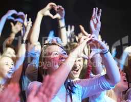 We love you. Adoring fans enjoying a music concert.