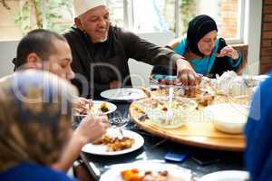 Food brings family together. Shot of a muslim family eating together.