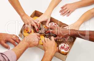 Doughnuts will do the job. A multitude of hands reaching to grab a doughnut from a box.