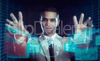 A businessman using futuristic touch technology to trade shares. All screen content is designed by us and not copyrighted by others, and upon purchase a user license is granted to the purchaser. A property release can be obtained if needed.