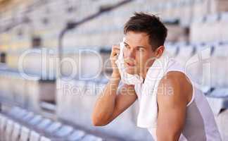 Sweating it out. Shot of an athlete taking a break from training.