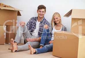 Its almost time to unpack. Shot of a happy young couple on their moving in day.