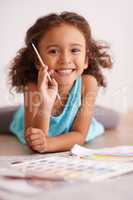 Rainbows are my favorite thing in the whole world. Shot of a little girl painting a picture of a rainbow.