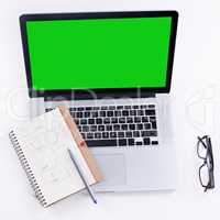 Tools to get the job done. Shot of a laptop with a green screen.