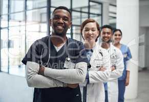 Not all heroes wear capes some wear labcoats. Shot of a group of medical staff together at work.