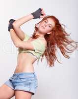 Shes got a hip hop swagger. Young woman dancing against a white background.