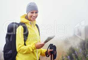 Which route shall I do today. Portrait of an attractive young woman standing in her hiking gear and holding a map.