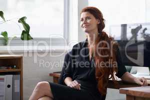 Dont quit your daydream. Shot of a beautiful young businesswoman sitting at her desk.