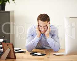 If only stress burned calories. An overwhelmed businessman sitting at his desk with his head in his hands.