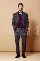 You know this bow tie looks cool. Full length studio portrait of a stylishly-dressed young man smiling at the camera.