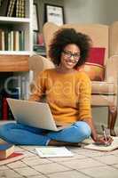 The internet is great when it comes to exam time. Full length portrait of a young woman using her laptop to study.