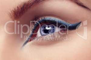 The eyes are the window to the soul. Close up of a blue eye with blue eyeliner.